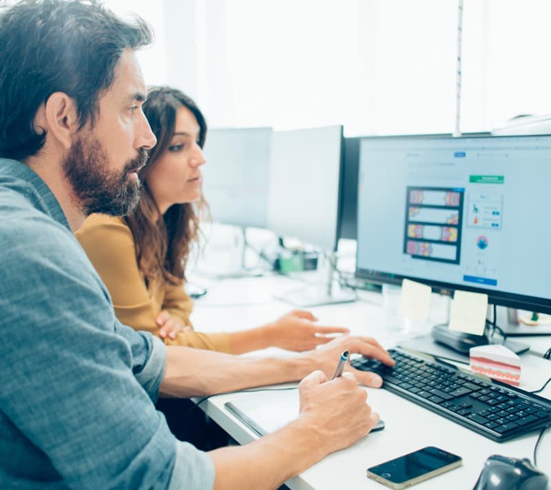 office Male and female colleagues viewing a computer screen