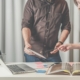 People working on a catalogue with a laptop