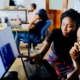 Two work colleagues looking at a computer screen together.