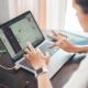 Woman using laptop for product data