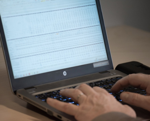 Spreadsheet showing product data on a laptop