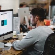 Male at a computer in an office environment.